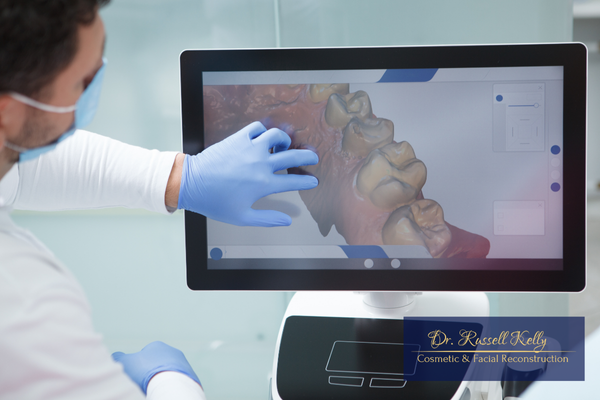 Patient in Orange, CA viewing digital dental scanner image with Dr. Kelly