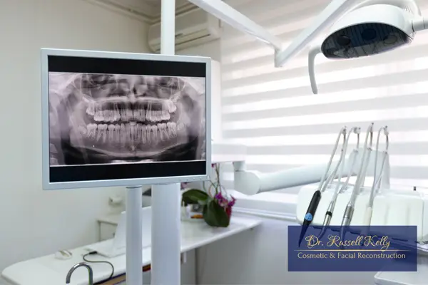 Patient reviewing AI-enhanced digital X-rays with Dr. Russell Kelly, DDS in Orange, CA